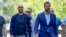Andrew Tate, left, and his brother Tristan, arrive flanked by bodyguards, at the Bucharest Tribunal in Bucharest, Romania, July 17, 2023. 