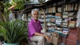 Hernando Guanlao, 72, sits in front of his home library in Makati, a metro area of Manila, Philippines, Feb. 7, 2024. (REUTERS/Eloisa Lopez)