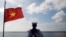 FILE - A Vietnamese sailor stands guard at Thuyen Chai island in the Spratly archipelago in the South China Sea on January 17, 2013. 