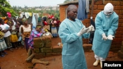 FILE - World Health Organization officials examine the home of a suspected Marburg virus victim in Uige, Angola, April 19, 2005. Tanzania on June 2, 2023, declared the end of a brief but deadly outbreak of the virus, WHO said.