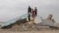 Children climb on a destroyed building in Zindan Jan, Afghanistan, Jan. 4, 2024, three months after a massive earthquake hit the area. 