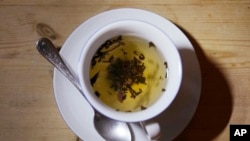 FILE - A cup of black tea with a spoon and tea leaves in London, on Aug. 29, 2022. 