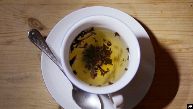 FILE - A cup of black tea with a spoon and tea leaves in London, on Aug. 29, 2022.