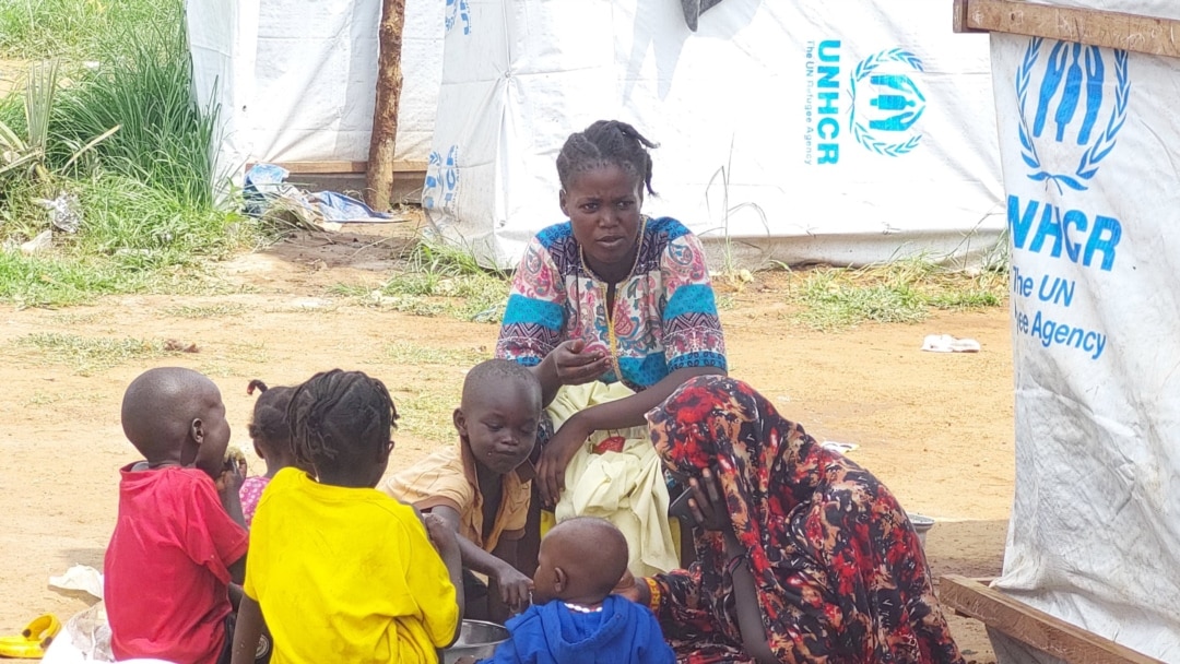 Sudanese refugee family sharing a meal at the UNHCR run Gorom refugee camp west of Juba South Sudan