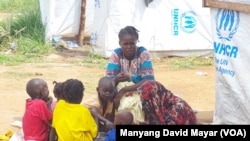 FILE - Sudanese refugee family sharing a meal at UNHCR-run Gorom refugee camp, west of the South Sudanese capital, Juba, Thursday July 20, 2023.