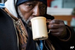 Pierre Bouyer wears a coat he got at Blanchet House, which offers meals and clothing to people experiencing homelessness, on Jan. 11, 2024, in Portland, Oregon.