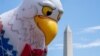 The Washington Monument is seen past a float during the National Independence Day Parade in Washington, on July 4, 2023.