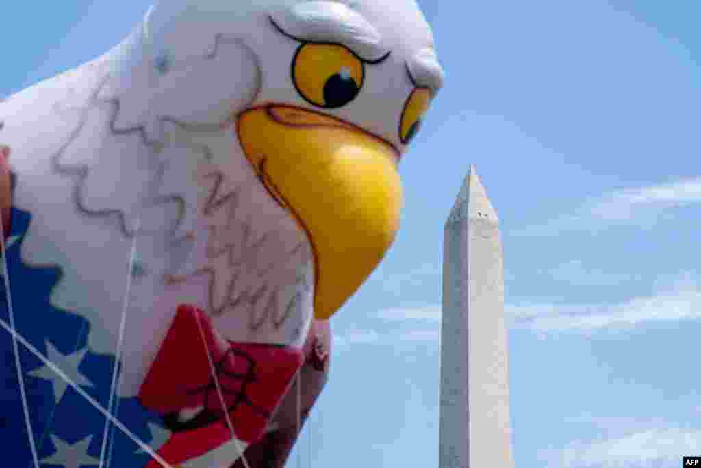 The Washington Monument is seen past a float during the National Independence Day Parade in Washington, on July 4, 2023.