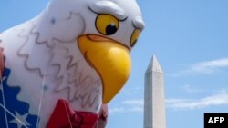 The Washington Monument is seen past a float during the National Independence Day Parade in Washington, July 4, 2023.