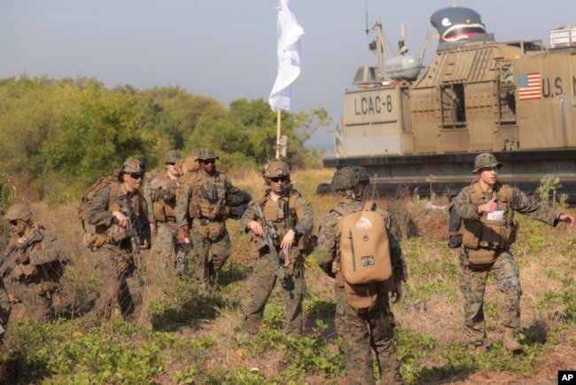 FILE - U.S. Marines take part in an amphibious landing operation at the Super Garuda Shield multinational military exercise in Situbondo, East Java, Indonesia, Sept. 10, 2023.