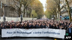 French personalities including Prime Minister Borne, former President Sarkozy, former President Hollande, Chief Rabbi of France Haim Korsia, and others sing the French national anthem during a march in Paris, Nov. 12, 2023. 