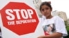 FILE - Khloe Marogi, 8, of West Bloomfield, Mich., wears a T-shirt with her detained father's photo on it at a rally on June 16, 2017, in Detroit. A judge approved a settlement in a lawsuit challenging the detentions.