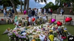 Flowers are laid down at a children's playground in Annecy, France, June 10, 2023 following a savage knife attack of four young children earlier in the week.