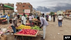 People gather at a market to buy food in Khartoum, June 10, 2023. A 24-hour ceasefire took effect on June 10, but fears are running high it will collapse like its predecessors and that U.S. and Saudi mediators warn they may break off mediation efforts.