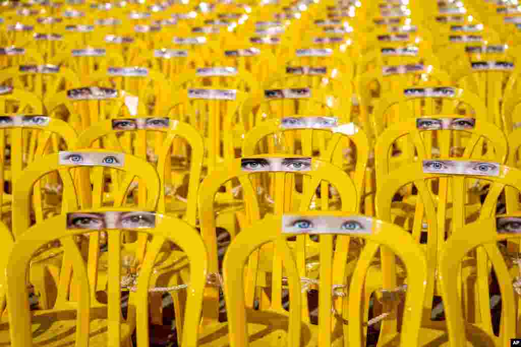 An installation of eyes on empty chairs symbol of the people missing and held captive in Gaza, in Tel Aviv, Israel. The hostages were kidnapped during an Oct. 7 Hamas cross-border attack in Israel and have been held in Gaza since then.