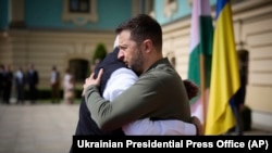 In this photo provided by the Ukrainian Presidential Press Office, Indian Prime Minister Narendra Modi, left, hugs Ukrainian President Volodymyr Zelenskyy in Kyiv, Ukraine, Aug. 23, 2024.