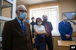 FILE - Members of Jehovah's Witnesses attend a court session in Perm, Russia, May 12, 2021.