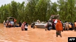 Foto tanggal 20 Agustus 2024 ini menunjukkan perahu polisi digunakan untuk mengevakuasi warga setelah hujan lebat yang merusak Jalan Nasional 25 dari ibu kota Niger, Niamey, ke provinsi Tillabéri dan Tahoua di Niger barat.