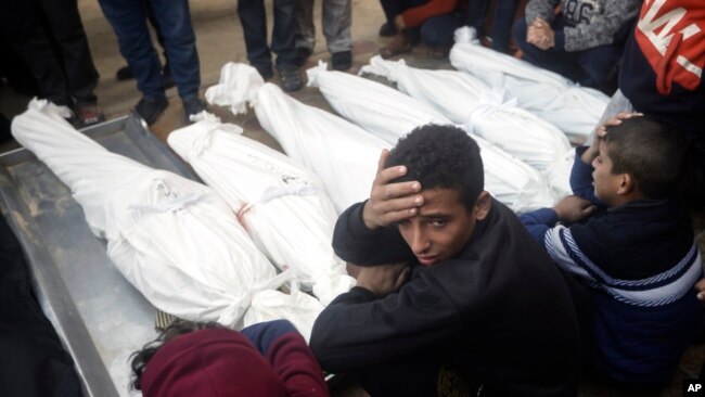 Palestinians mourn relatives killed in the Israeli bombardment of the Gaza Strip outside a morgue in Khan Younis on Jan. 4, 2024.