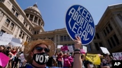 FILE - Abortion rights demonstrators attend a rally at the Texas state Capitol in Austin, Texas, May 14, 2022.