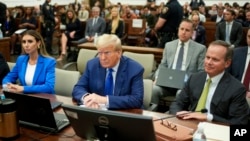 FILE - Former U.S. President Donald Trump, center, with his legal team, attends his civil business fraud trial at New York Supreme Court, Oct. 25, 2023. A judge ruled on Feb. 16, 2024, that Trump must pay $354.9 million in penalties.