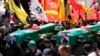 Hamas fighters carry mock coffins of Hamas political chief Ismail Haniyeh and his bodyguard, who were killed in an assassination in Tehran, during a symbolic funeral in Beirut, Lebanon, Aug. 2, 2024.