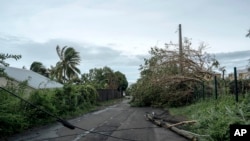 Electrical poles and trees fell on the road in the town of La Plaine Saint-Paul on the French Indian Ocean island of Reunion, Jan. 15, 2024.