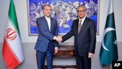 In this photo released by Pakistan's Ministry of Foreign Affairs, visiting Iranian Foreign Minister Hossein Amirabdollahian, left, shakes hands with his Pakistani counterpart, Jalil Abbas Jilani, in Islamabad, Jan. 29, 2024.