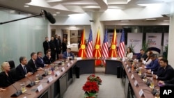 U.S. Secretary of State Antony Blinken, second left, talks to North Macedonia's Foreign Minister Bujar Osmani, right, during a bilateral meeting of their delegations at the foreign ministry building in Skopje, North Macedonia, Nov. 29, 2023.