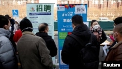 FILE - Job seekers attend a job fair in Beijing, China, Feb. 16, 2023.