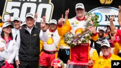 Josef Newgarden celebrates with his team and car owner Roger Penske, left, after winning the Indianapolis 500 auto race at Indianapolis Motor Speedway in Indianapolis, May 28, 2023. 