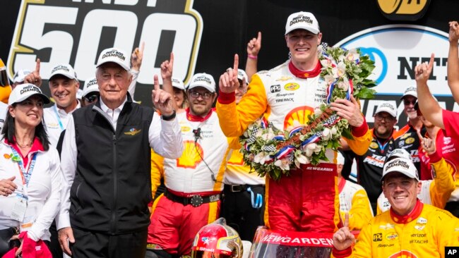 Josef Newgarden celebrates with his team and car owner Roger Penske, left, after winning the Indianapolis 500 auto race at Indianapolis Motor Speedway in Indianapolis, May 28, 2023.