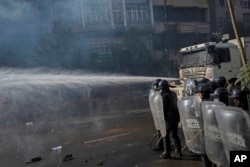 Nepalese police use water cannon to disperse protestors demanding a restoration of Nepal's monarchy in Kathmandu, Nov. 23, 2023.