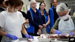 A team of experts from the International Atomic Energy Agency observes local staff preparing a sample fish from Fukushima, for analysis of radioactivity, at Marine Ecology Research Institute in Onjuku, Chiba Prefecture near Tokyo, Japan, Oct. 20, 2023.