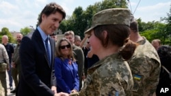 Canadian Prime Minister Justin Trudeau, left, with Deputy Prime Minister and Minister of Finance Chrystia Freeland, center, meets with soldiers in Kyiv, Ukraine, June 10, 2023.