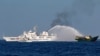 FILE - Chinese Coast Guard vessels fire water cannons towards a Philippine resupply vessel Unaizah May 4 on its way to a resupply mission at Second Thomas Shoal in the South China Sea, March 5, 2024.