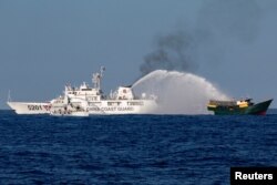 Chinese Coast Guard vessels fire water cannons towards a Philippine resupply vessel Unaizah May 4 on its way to a resupply mission at Second Thomas Shoal in the South China Sea, March 5, 2024.