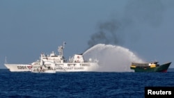 资料照：中国海岸警卫队在第二托马斯礁附近向菲律宾执行补给任务的民用船只发射水炮。（2024年3月5日）