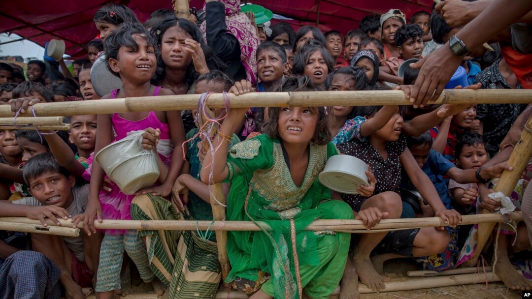 FILE - Rohingya Muslim children refugees, who crossed over from Myanmar into Bangladesh, wait to receive food handouts distributed to children and women by a Turkish aid agency, Oct. 21, 2017, at Thaingkhali refugee camp, Bangladesh.