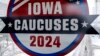 Muškarac hoda preko ulice ispod znaka za Iowa Caucuses u centru Des Moinesa, Iowa, 13. januara 2024.