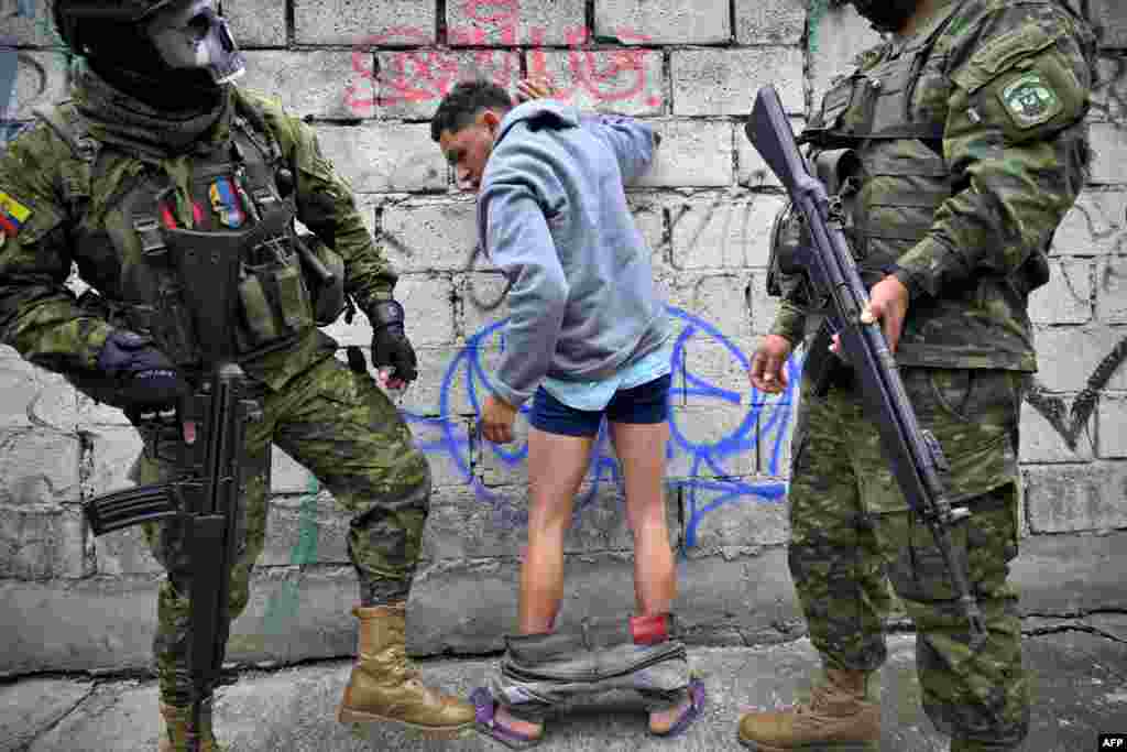 Members of the Army frisk a man during a patrol in the Lucha de los Pobres neighborhood in southern Quito, as Ecuador is in a "state of emergency" since the prison escape of one of the country's most powerful narco bosses. 