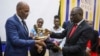 Haitian Prime Minister Ariel Henry, left, is presented a gift by Korir SingOei, Kenya's secretary for foreign affairs, at the United States International University (USIU) in Nairobi, Kenya, March 1, 2024.