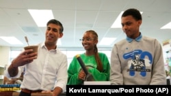 British Prime Minister Rishi Sunak takes part in a sustainability project as he visits the Friendship Technology Preparatory High School during his trip to Washington, June 7, 2023. (Kevin Lamarque/Pool Photo via AP)