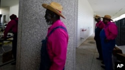 Members of the McIntosh County Shouters get ready to perform at the dedication ceremony to open the International African American Museum, June 24, 2023, in Charleston, S.C.