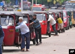 FILE - Auto rickshaw drivers line up to buy gas near a fuel station in Colombo, Sri Lanka, on April 13, 2022. The country is struggling to come out from an unprecedented economic crisis that has engulfed it since last year.