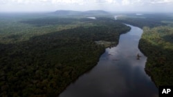 FILE - The Essequibo River flows through the Kurupukari crossing in Guyana, Nov. 19, 2023. Venezuela has long claimed Guyana's Essequibo territory, a region larger than Greece.