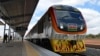 FILE - One of Kenya's newly acquired standard gauge rail locomotive rolls into Voi railway station on May 31, 2017, in Voi, Kenya, on the inaugural ride of Kenya's new China-financed standard gauge railway from the city of Mombasa to the capital, Nairobi.