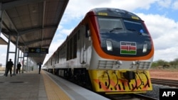 FILE - One of Kenya's newly acquired standard gauge rail locomotive rolls into Voi railway station on May 31, 2017, in Voi, Kenya, on the inaugural ride of Kenya's new China-financed standard gauge railway from the city of Mombasa to the capital, Nairobi.