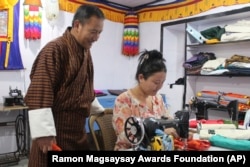 This undated photo provided by the Ramon Magsaysay Award Foundation shows the 2024 Ramon Magsaysay Award winner, Karma Phuntsho, left, of Bhutan. (Ramon Magsaysay Awards Foundation via AP)