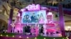 A screen shows America Ferrera, L, director Greta Gerwig, center, and Margot Robbie, R, during the pink carpet event for the movie "Barbie" in Seoul, South Korea, July 2, 2023. Vietnam's state media have reported that the government banned distribution of the popular movie.